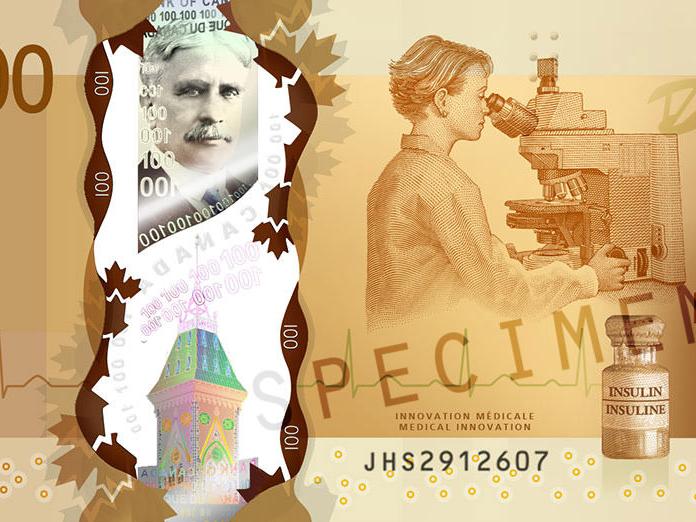 Diğer şeylerin yanı sıra bir ZEISS mikroskobu gösteren Kanada 100 dolarlık banknotun yakından görünümü.