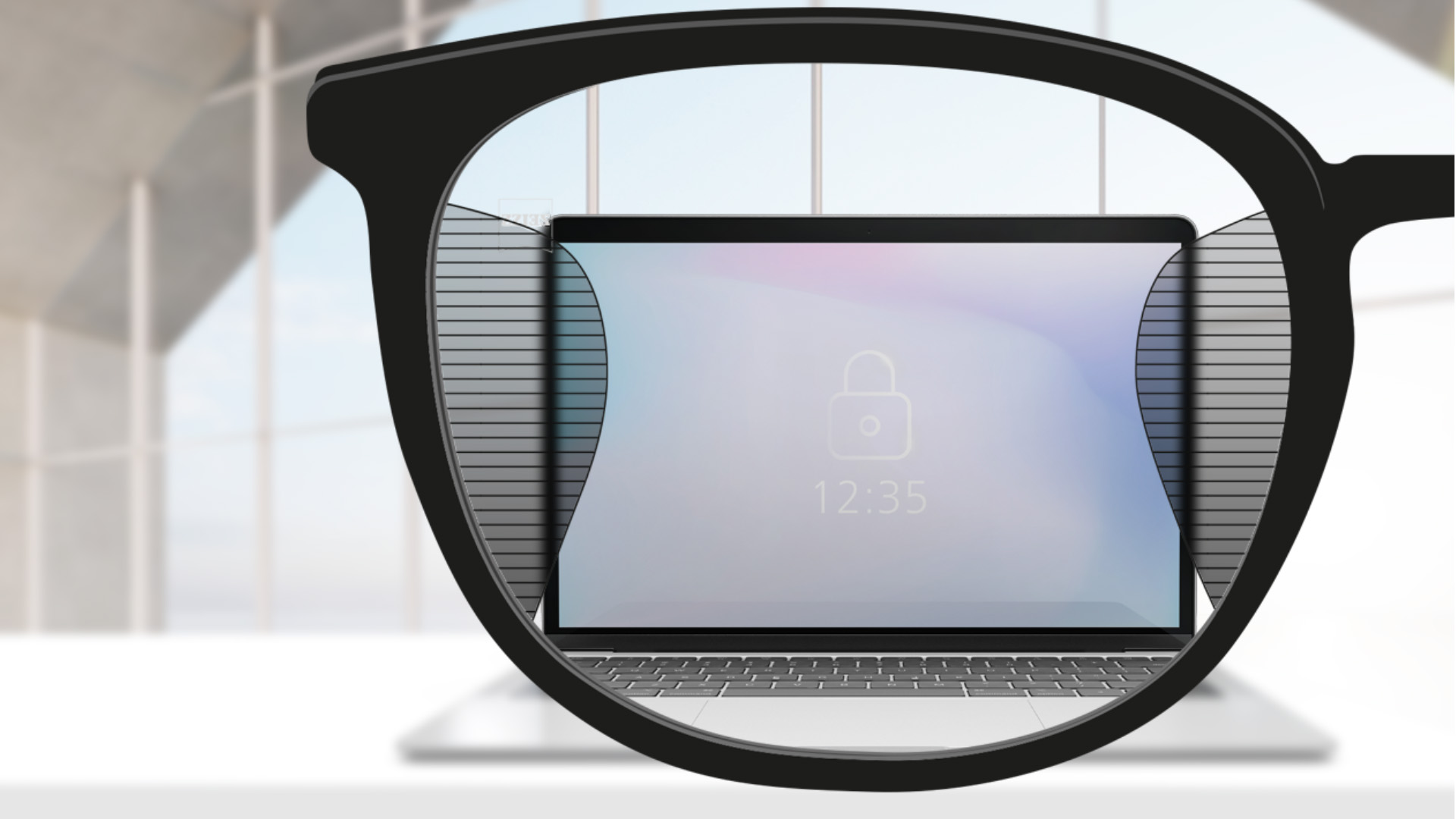 ZEISS Ofis lensleri ile çekilmiş, lensin merkezinde bilgisayar ekranı ve sağda ve solda ince, bulanık çizimler bulunan bir bakış açısı görüntüsü.